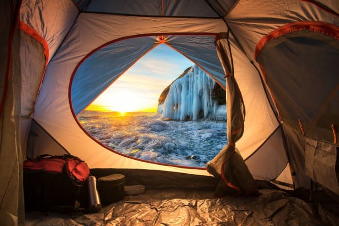 View from a tent during Iceland camping trip with beautiful winter landscape at sunrise