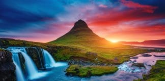 Kirkjufell volcano at sunset in Iceland with waterfall
