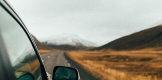 View from the side of a camper on a road trip