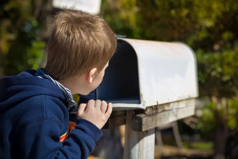 Little boy checking the mail for his family's Iceland Campingcard