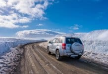 Car driving on icy, ashy, sandy roads in Iceland