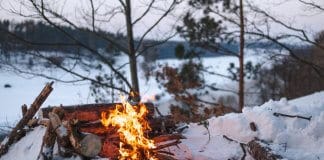 Campfire on snow during camping trip in Iceland