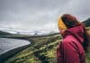 Female tourist looking at the mossy landscape while camping in Iceland