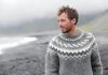 Handsome Icelandic man having a walk along the black sand beach in Iceland