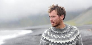 Handsome Icelandic man having a walk along the black sand beach in Iceland