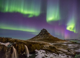 Winter landscape in Iceland with the Northern Lights dancing in the sky