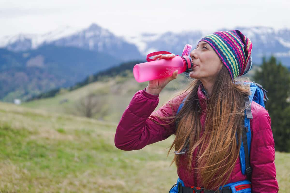 Iceland tap water drunk by female hiker from plastic reusable bottle
